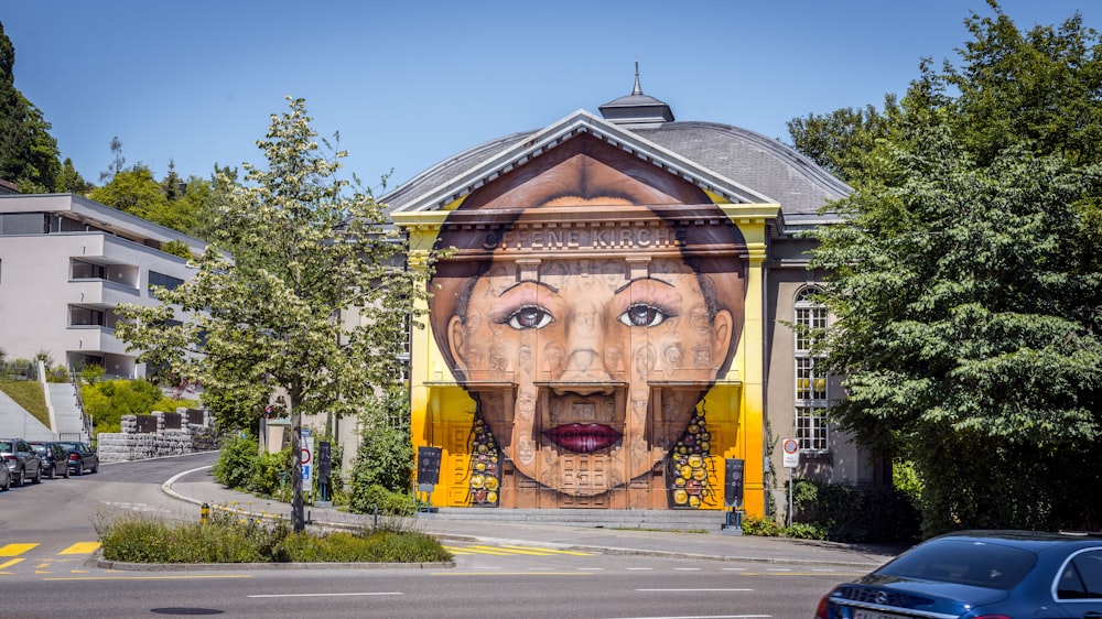 a large mural of a woman's face on the side of a building