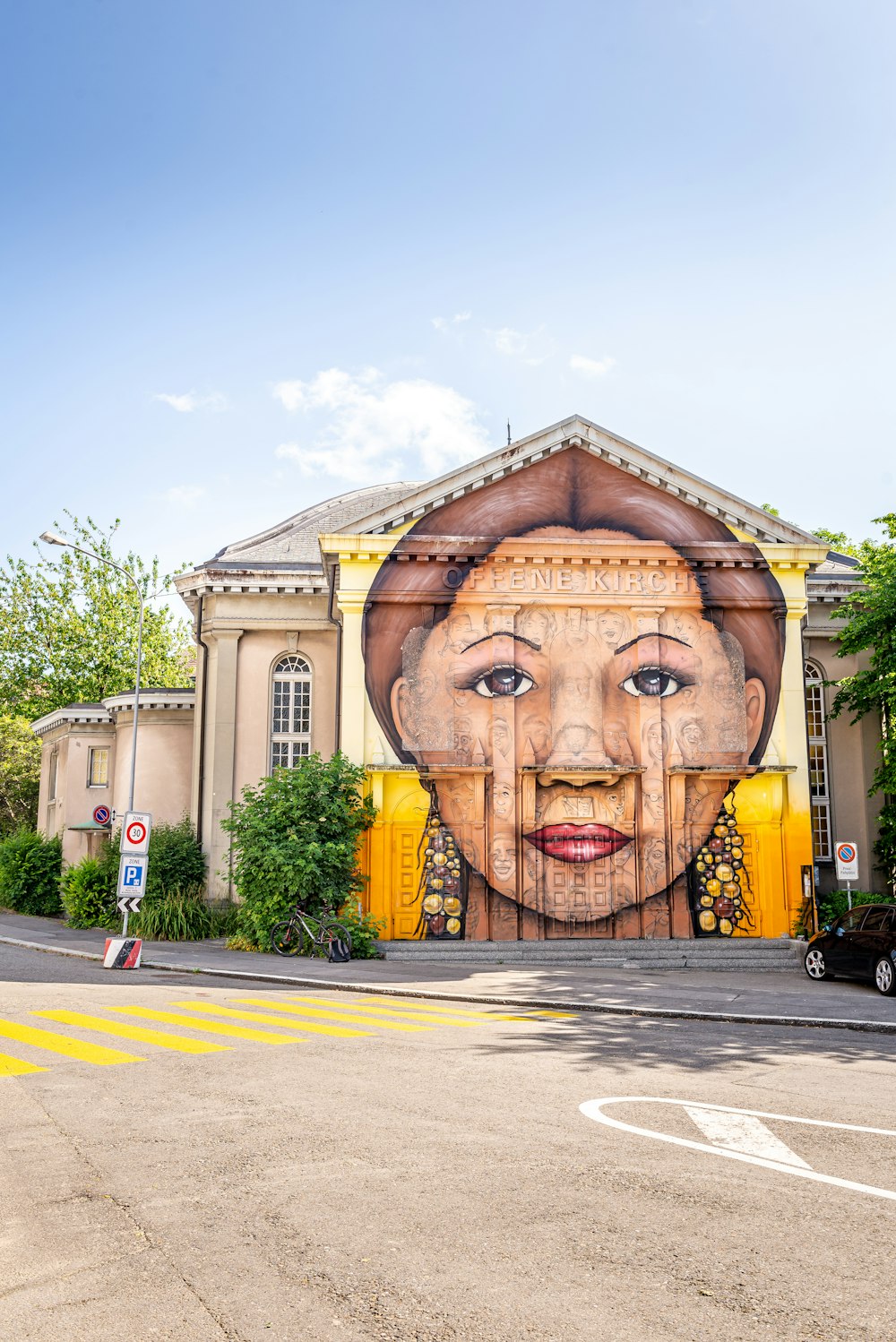 a large mural of a woman's face on the side of a building