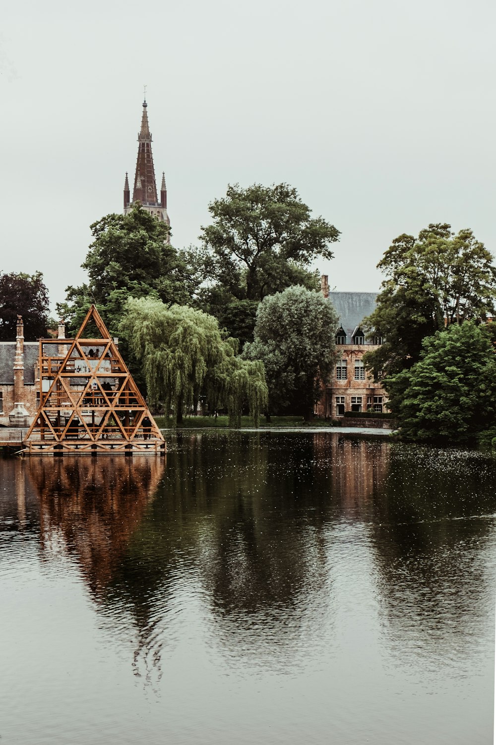 a small clock tower in the middle of a body of water