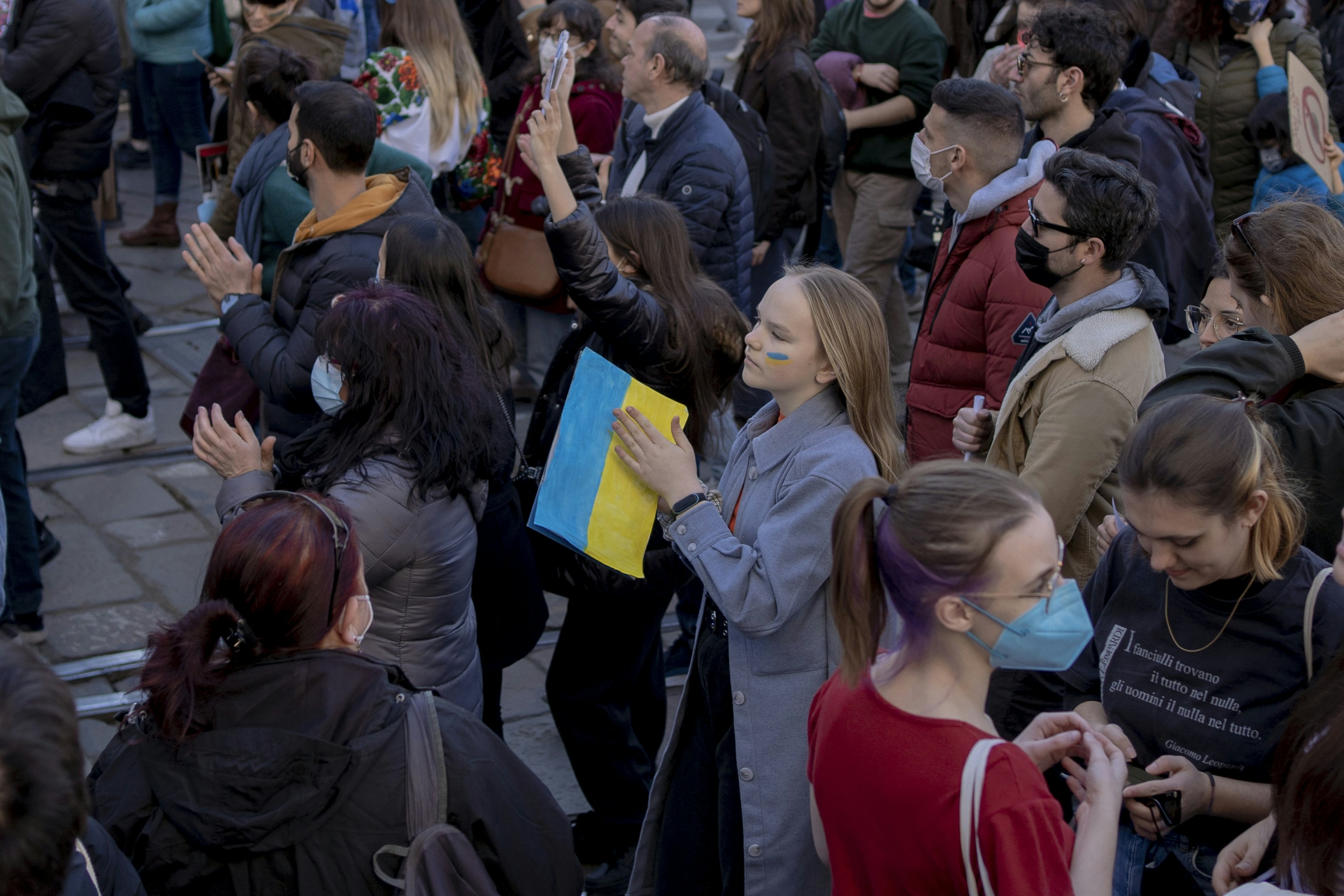 a crowd of people standing around each other