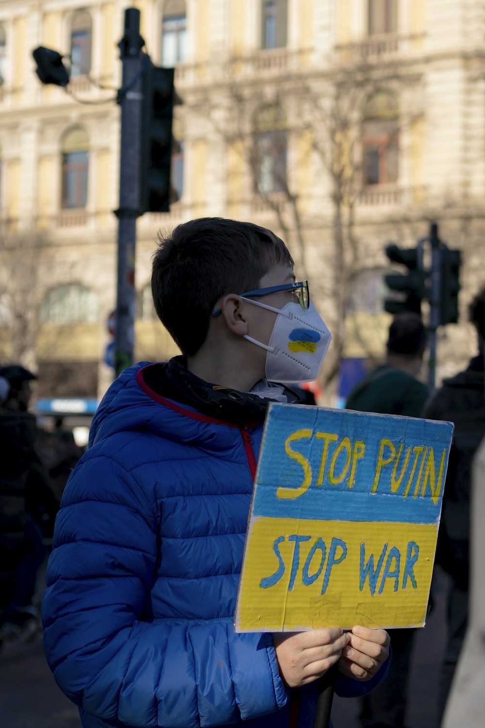 a man in a blue jacket holding a sign