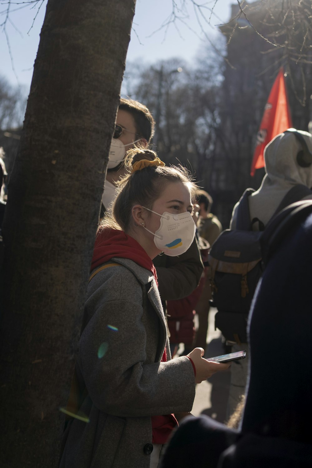 a group of people standing around each other wearing face masks