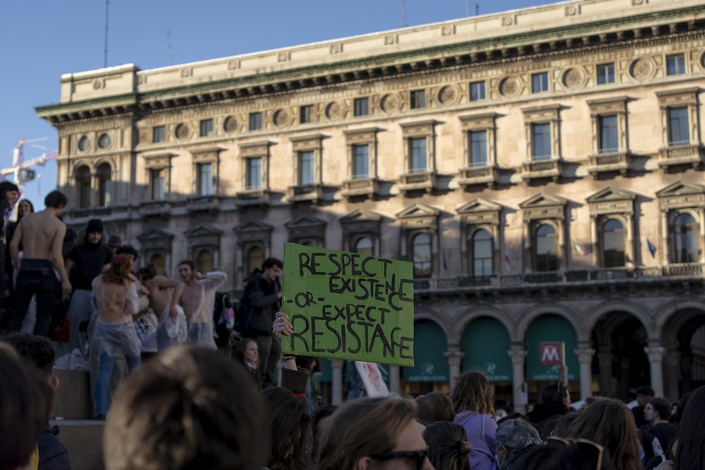 a crowd of people standing in front of a building