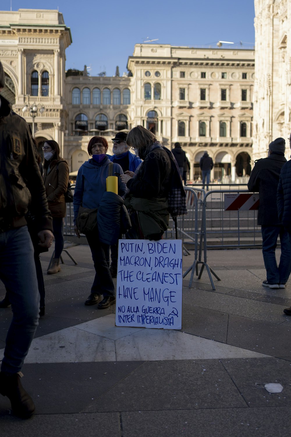 a group of people standing around a sign