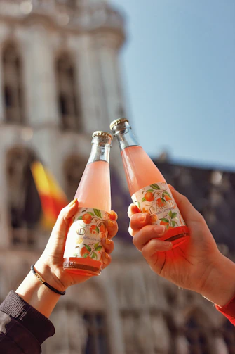 a couple of people holding up some drinks