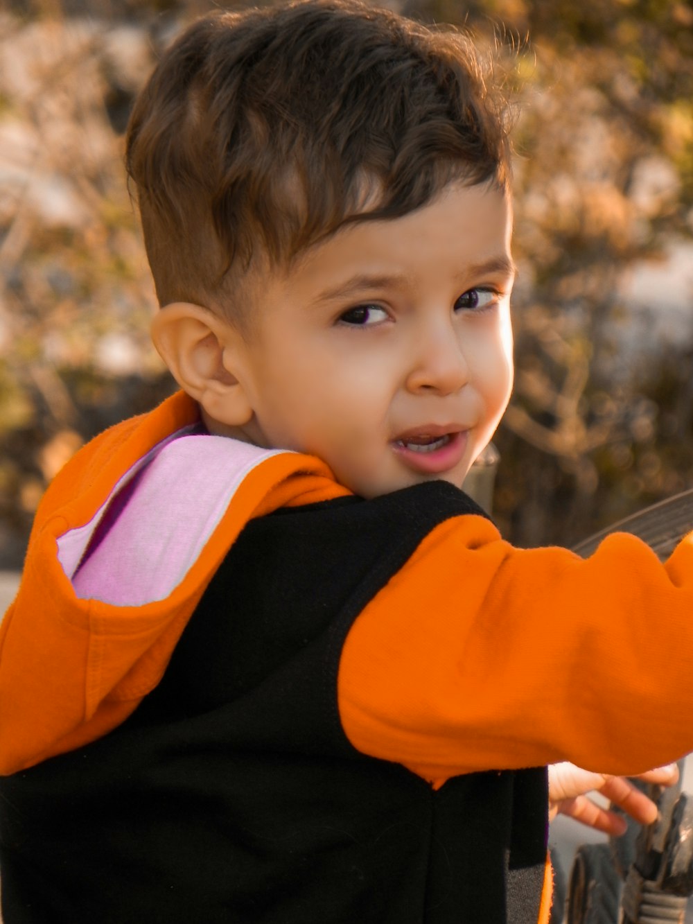 a young boy holding a tennis racket in his hand