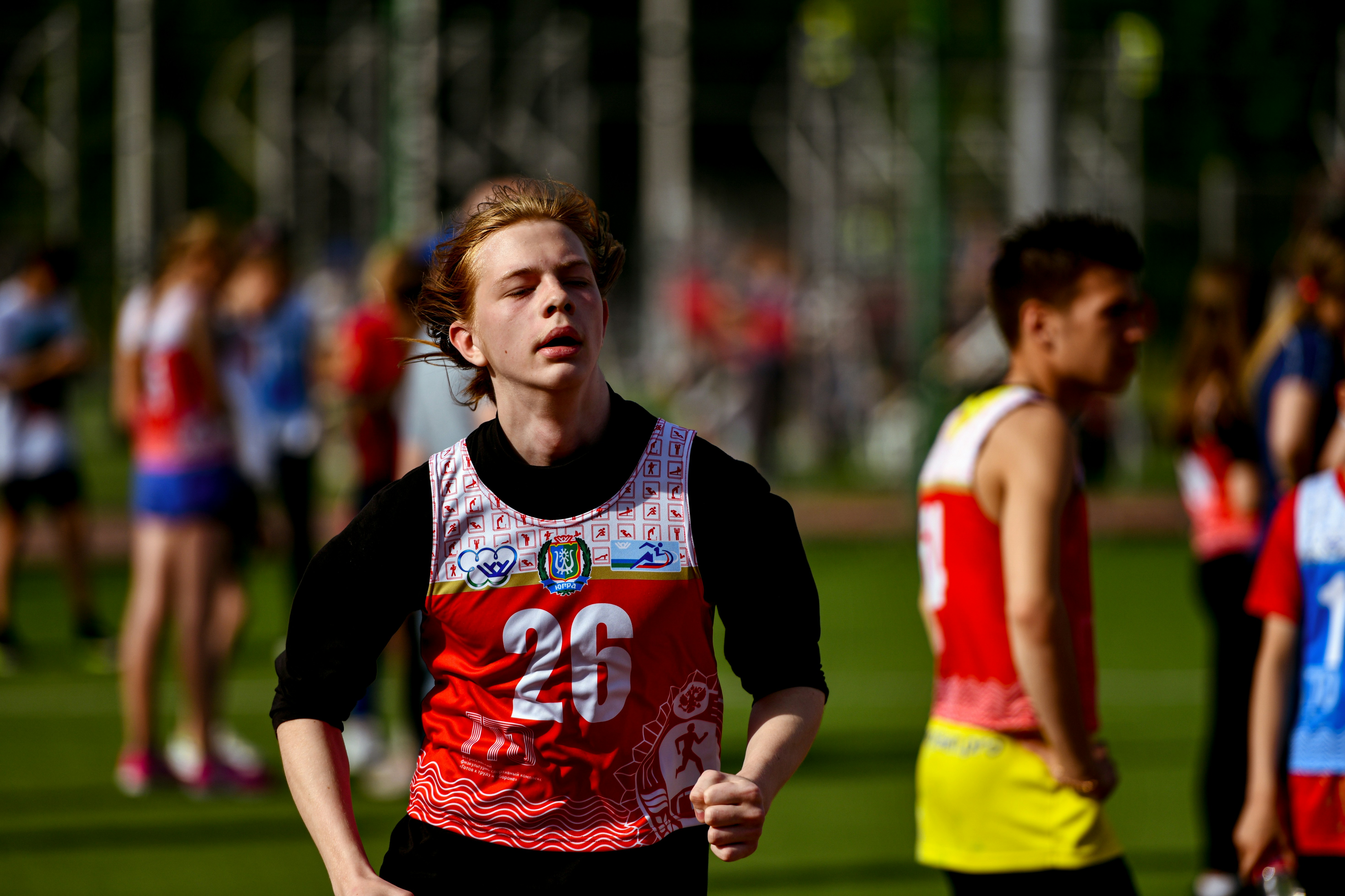 a man running in a race with other people behind him
