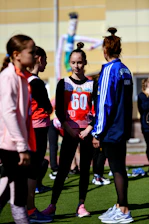 a group of people standing around each other on a field