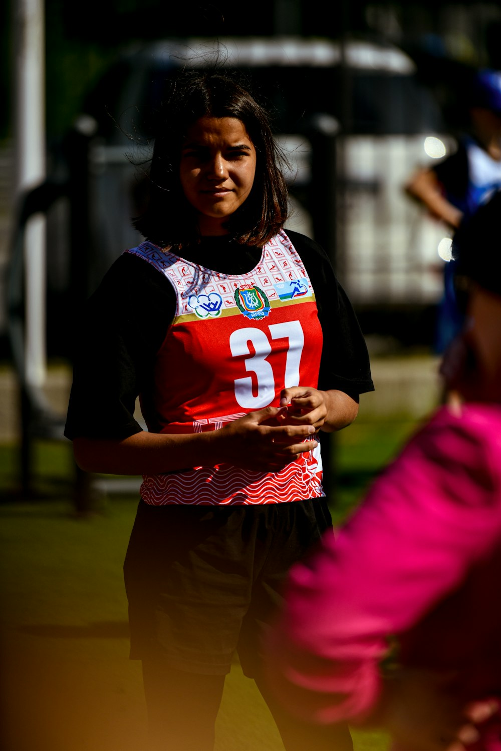 a woman standing next to another woman in a park