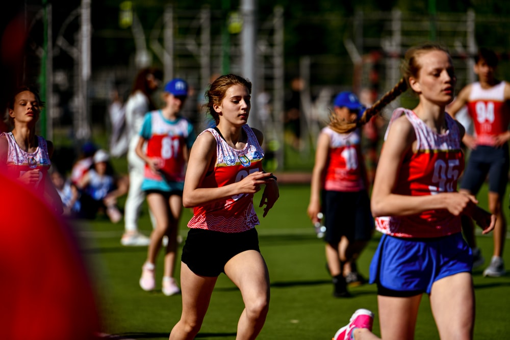 a group of people running on a field