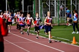 a group of young people running on a track