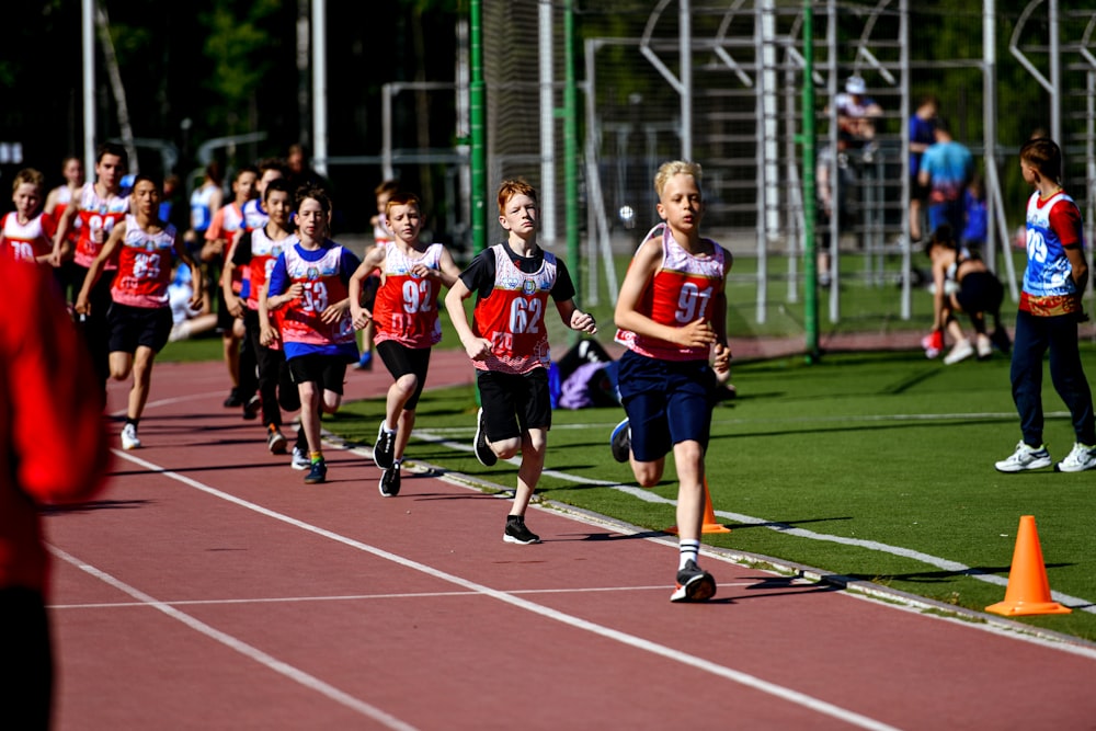 a group of young people running on a track