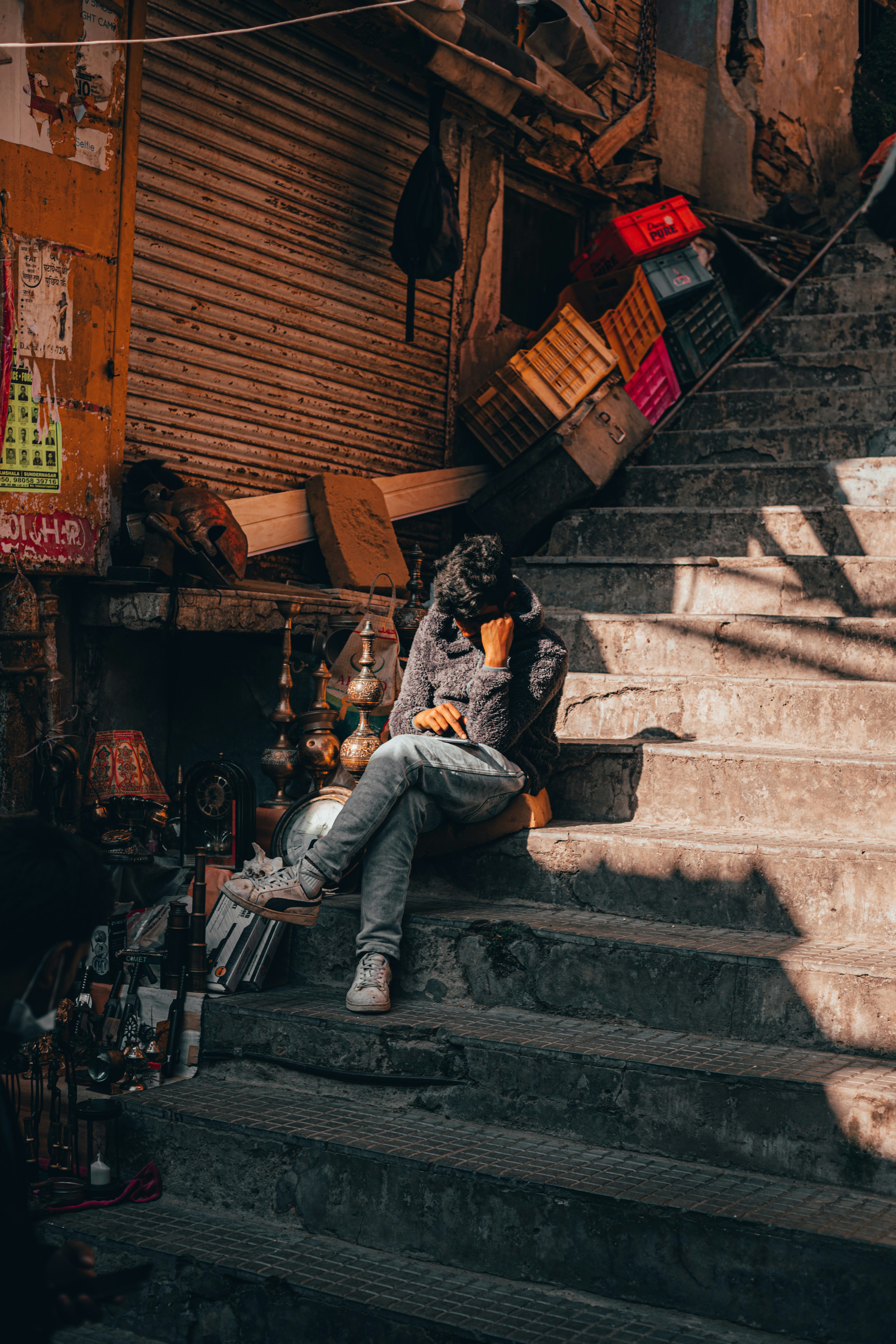 a man sitting on the steps of a building