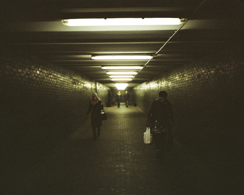 a group of people walking through a tunnel