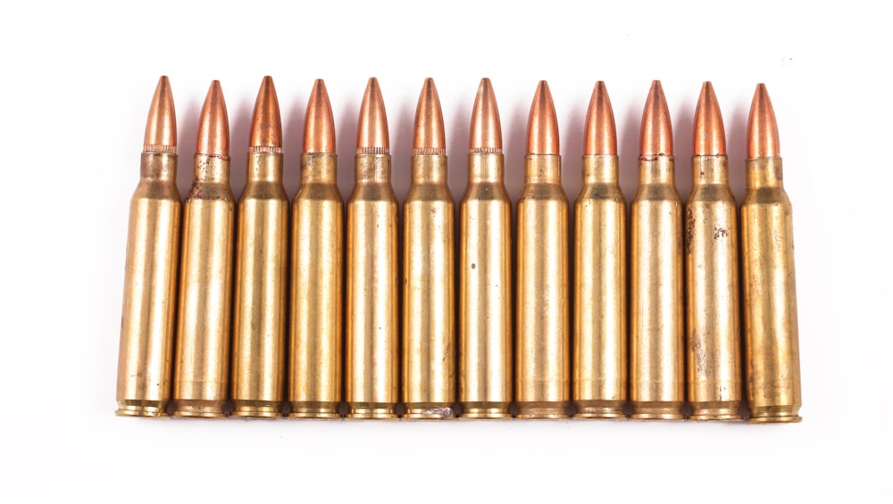 a bunch of bullet shells on a white background