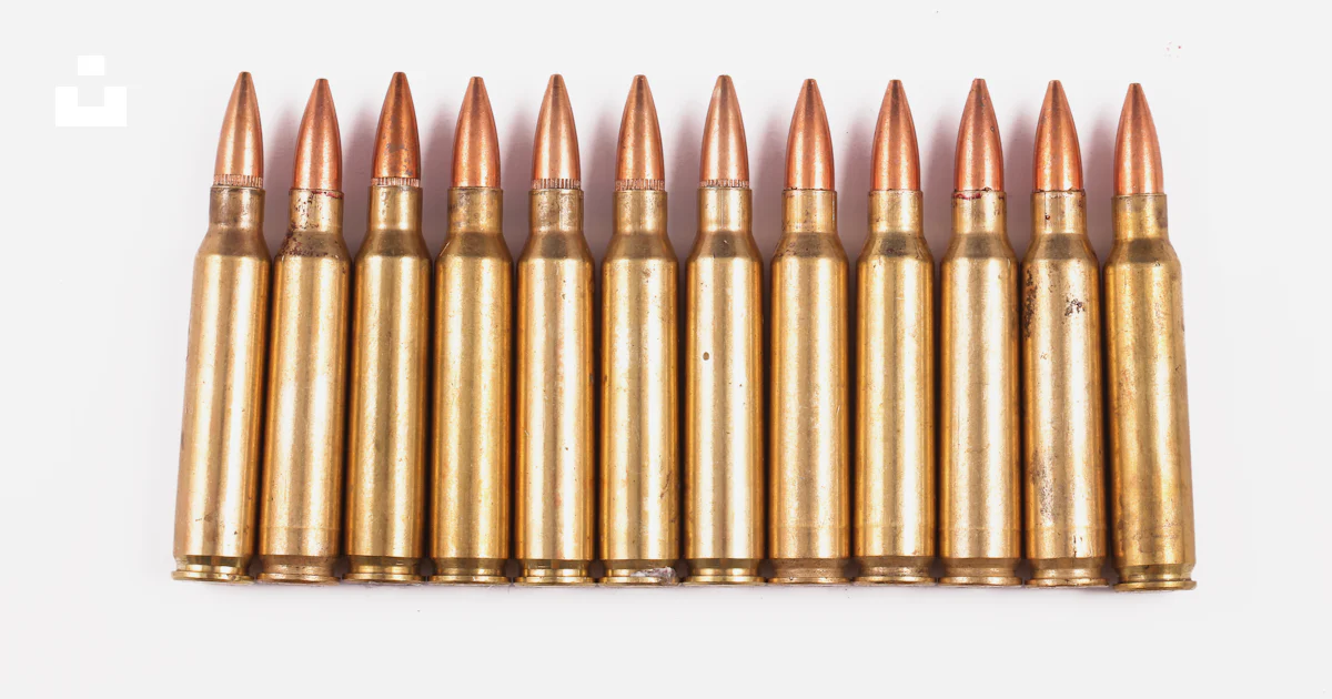 A bunch of bullet shells on a white background photo – Free Ammunition ...