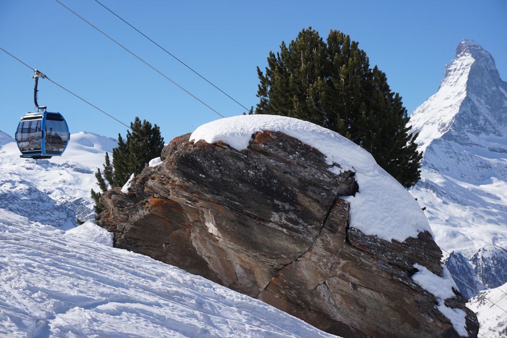 a person riding a ski lift on a snowy mountain