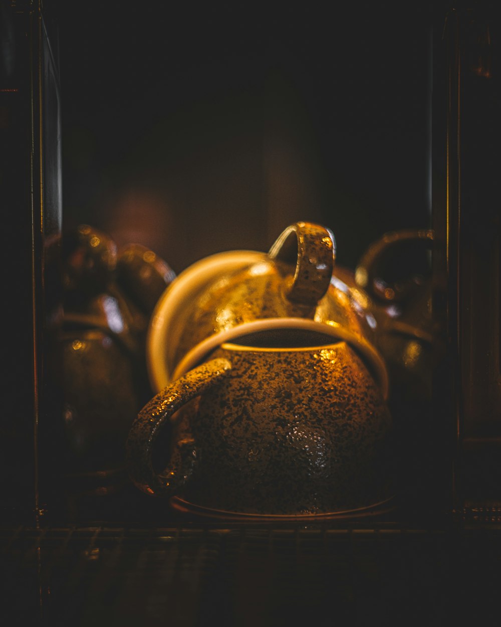 a close up of a tea pot on a shelf