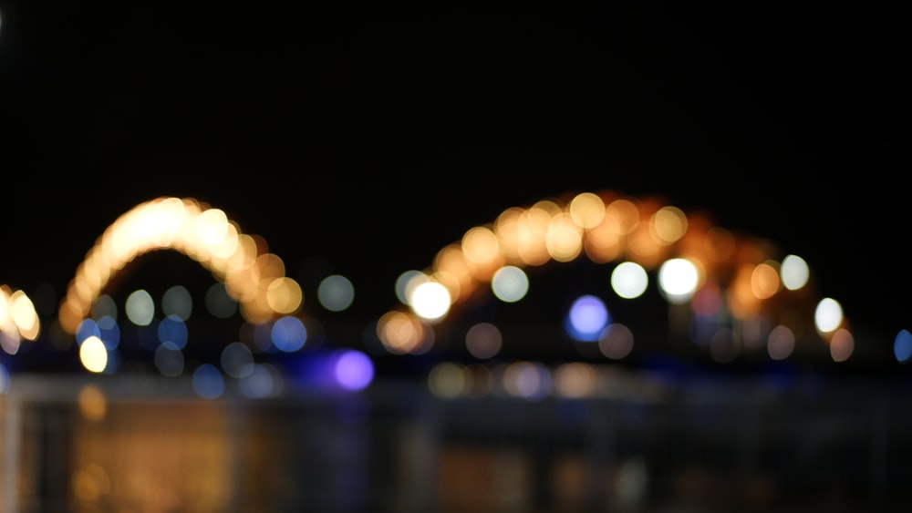 a blurry photo of a bridge at night