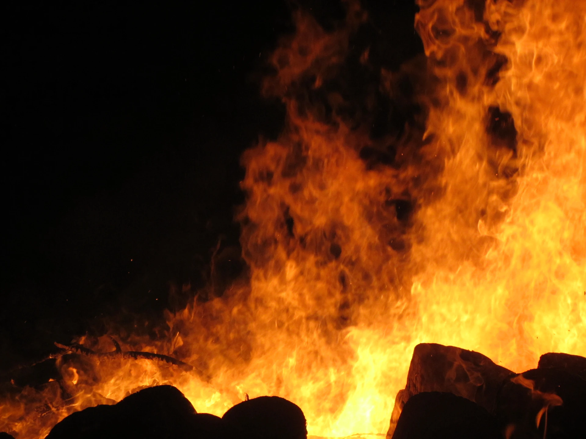 a large fire is burning in the dark