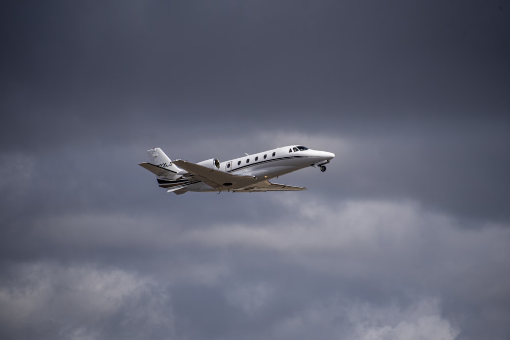 a small plane flying through a cloudy sky