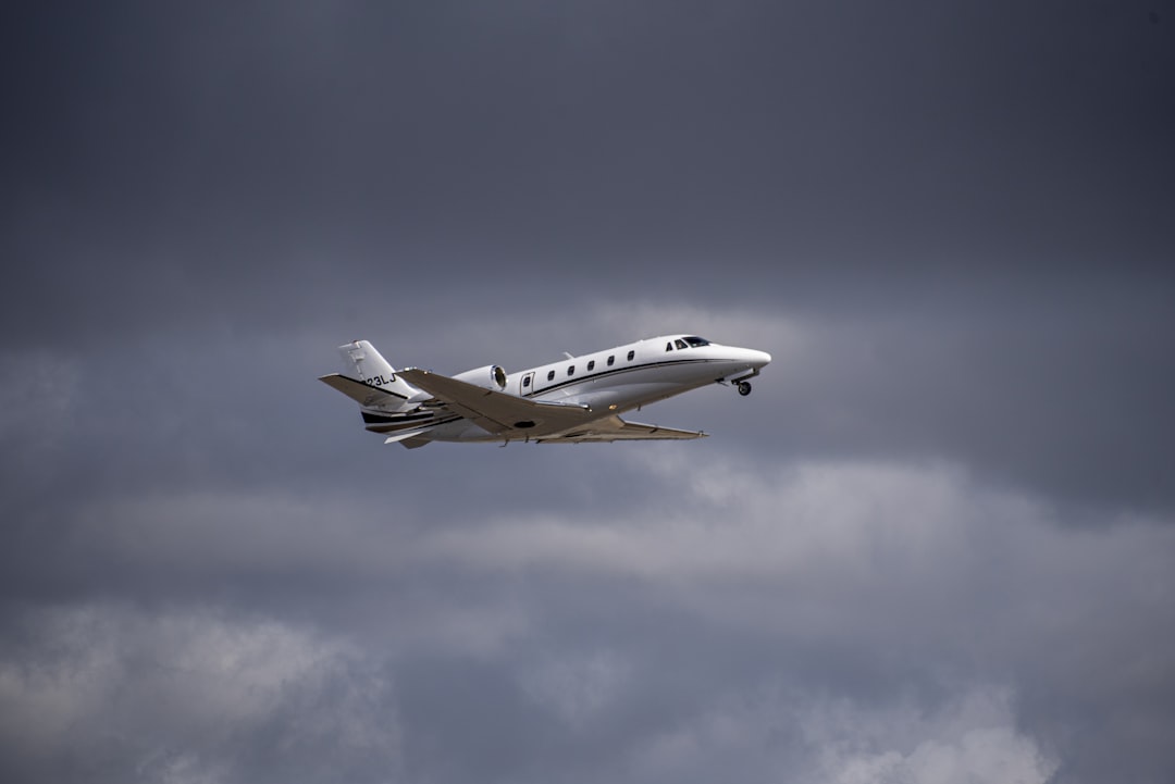 a small plane flying through a cloudy sky,