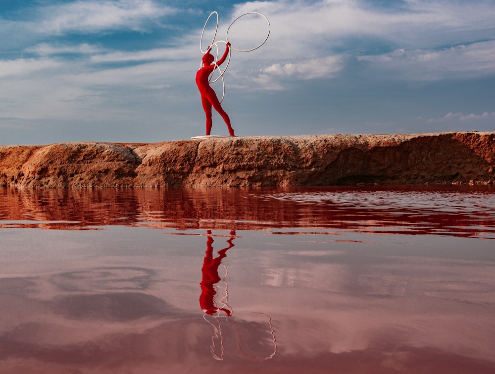 a woman with a hoop is standing in the water