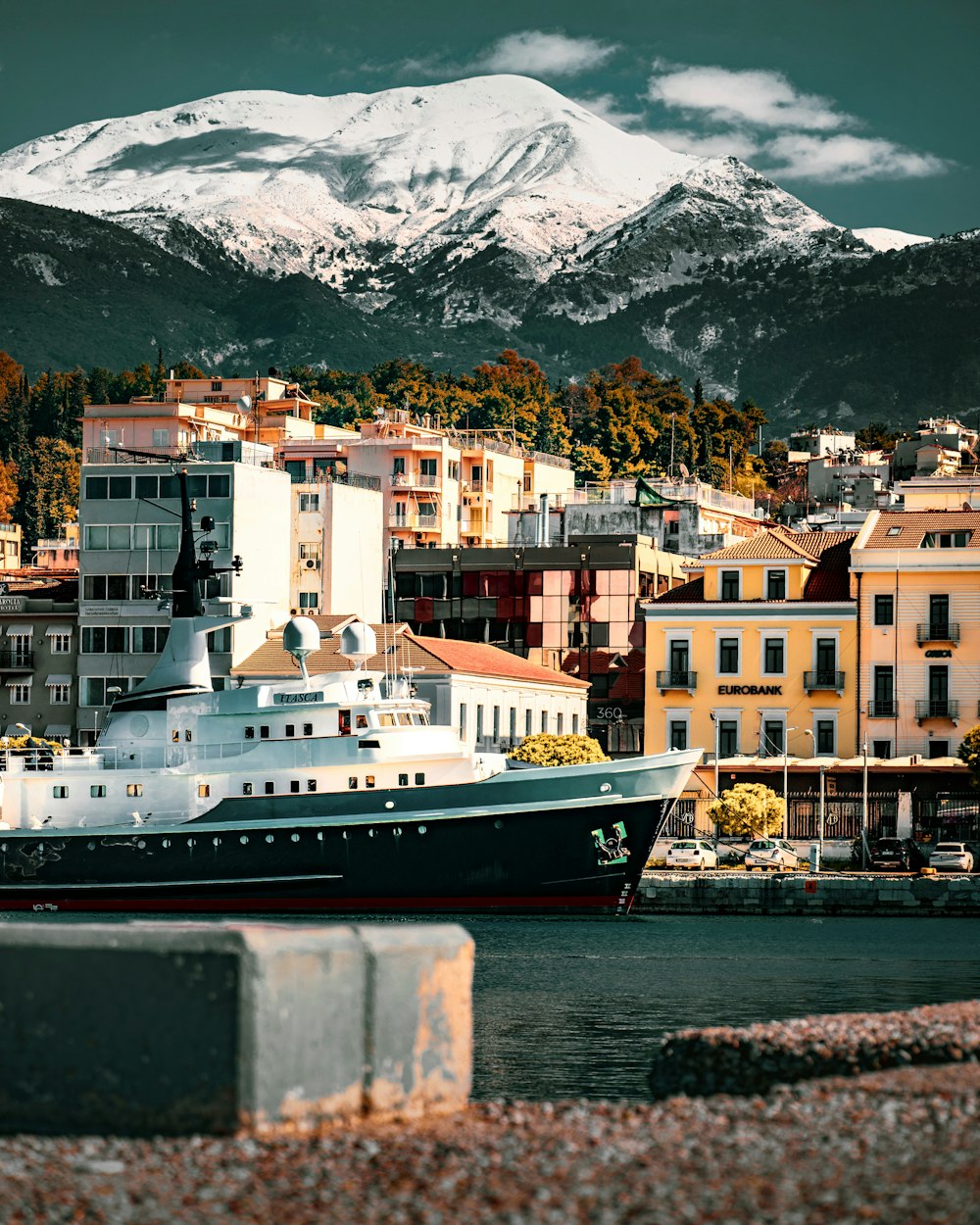 a large boat in the water near a city