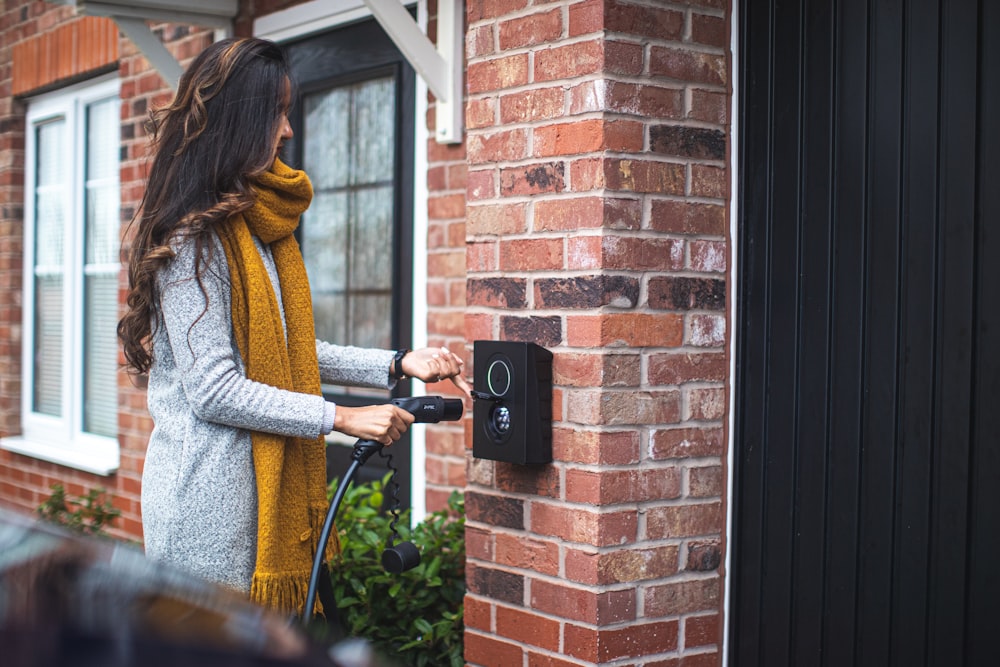 a woman is opening the door of her house