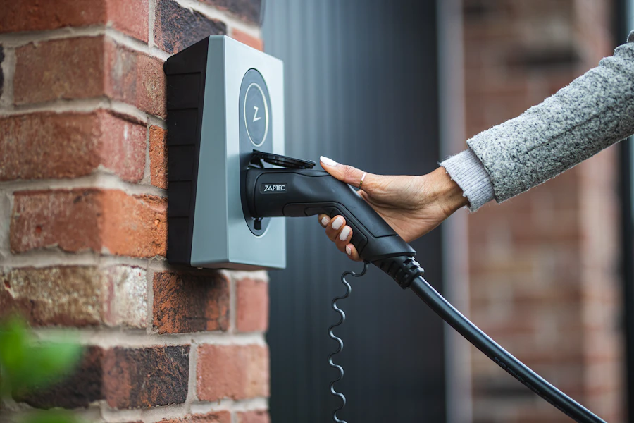 Plugging a charging cable into a wall charger