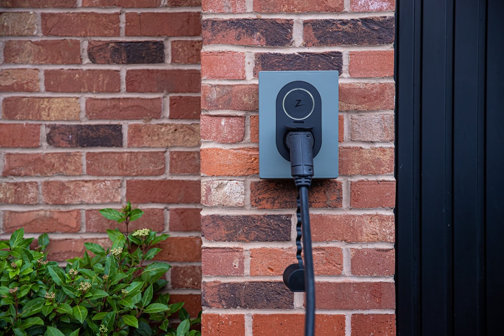 an electric plugged in to a brick wall