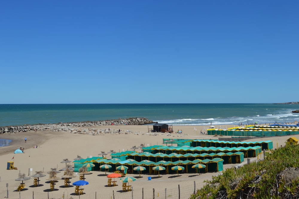 a beach with a lot of umbrellas and chairs