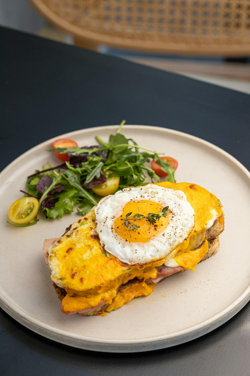 a white plate topped with an omelet and a salad