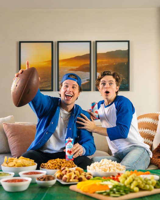 A group of friends enjoying a football match on a TV.