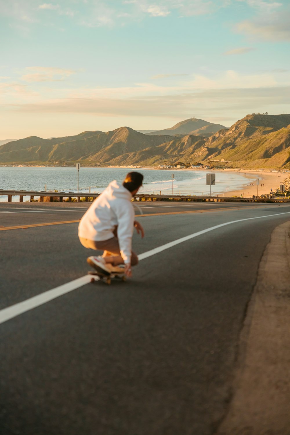 a man riding a skateboard down the middle of a road