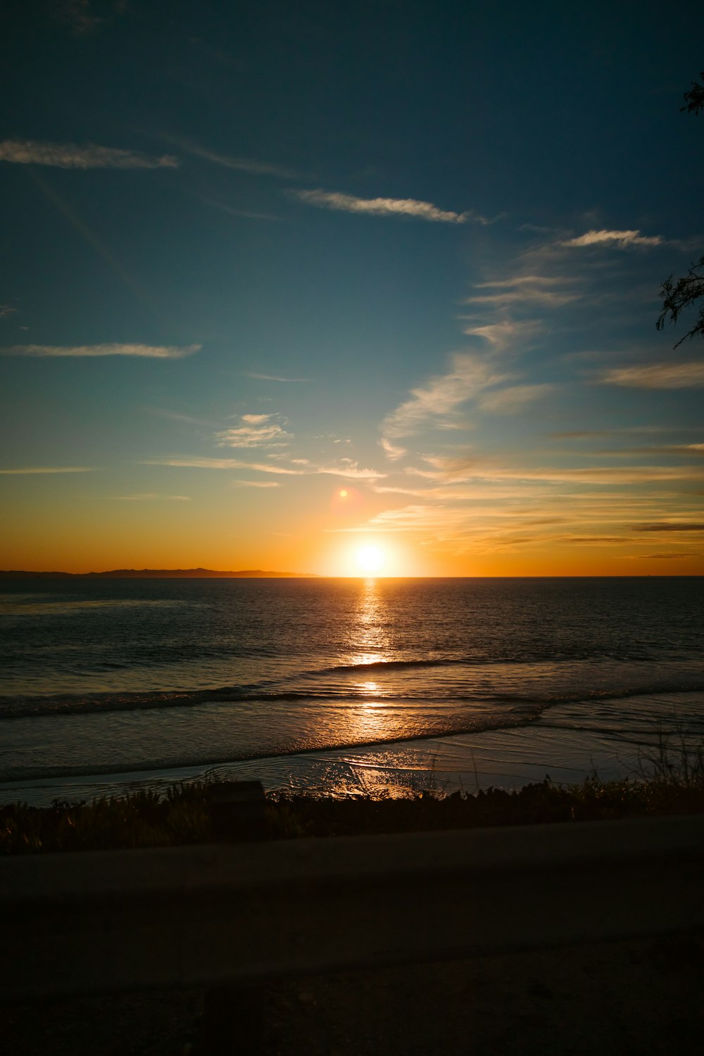 the sun is setting over the ocean on a clear day