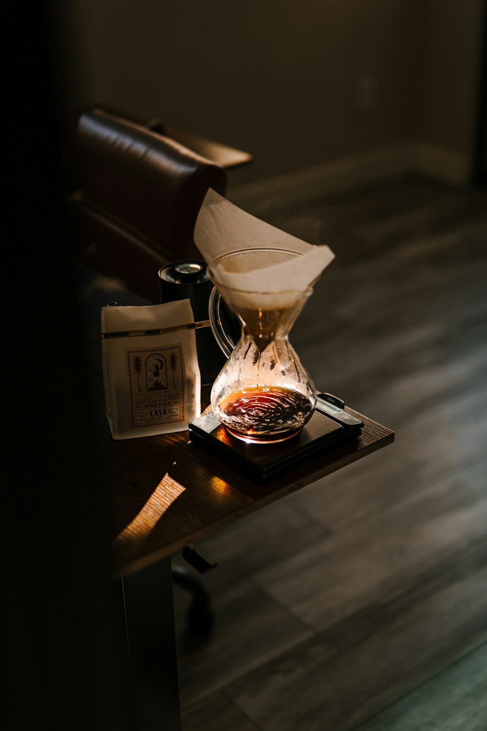 a coffee pot sitting on top of a wooden table