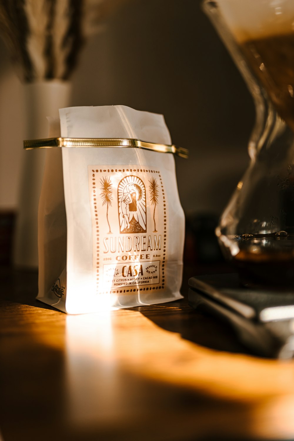 a bag of coffee sitting on top of a wooden table