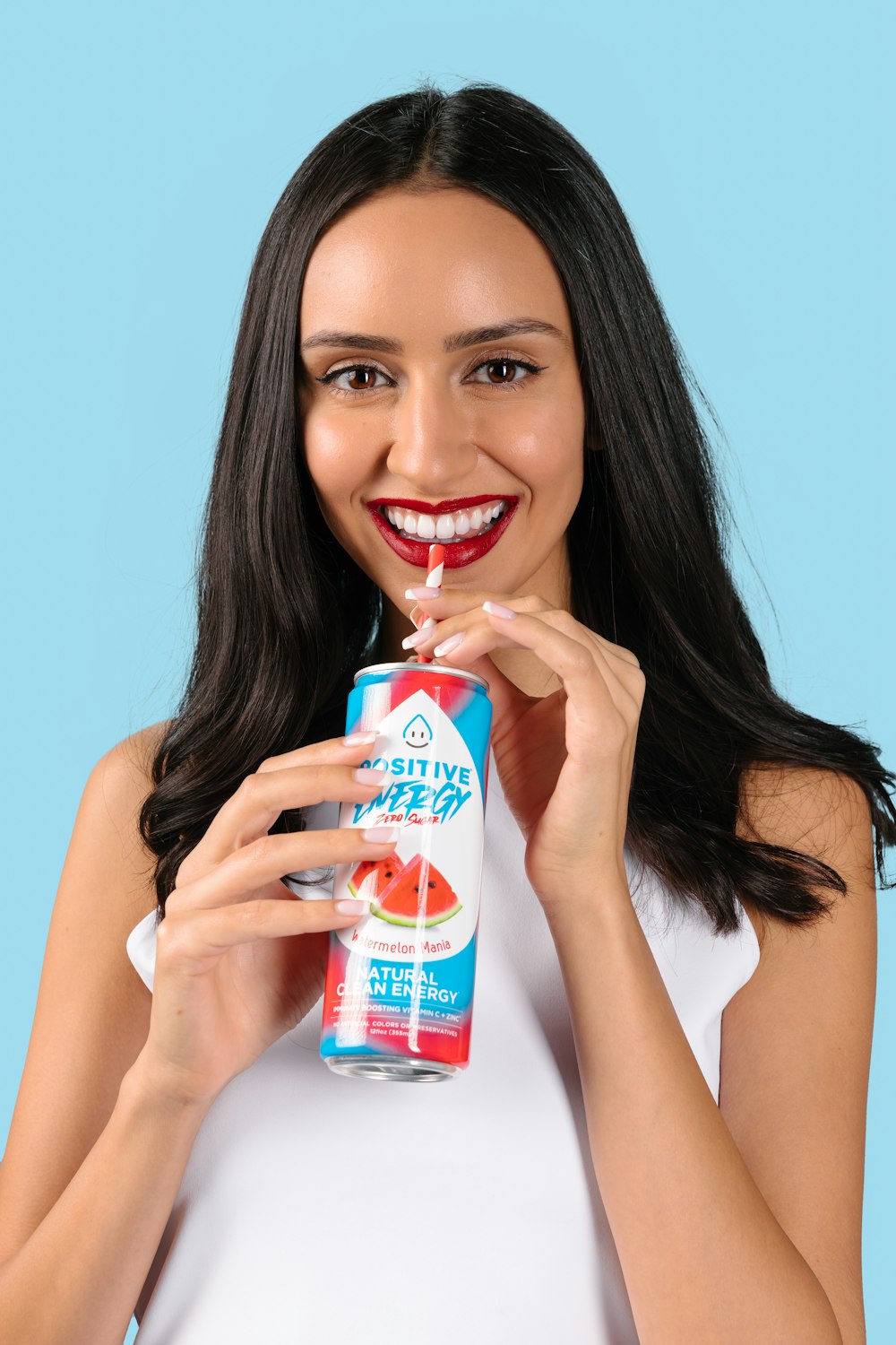 a woman is holding a can of soda