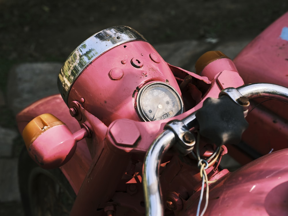 a close up of a pink motor bike