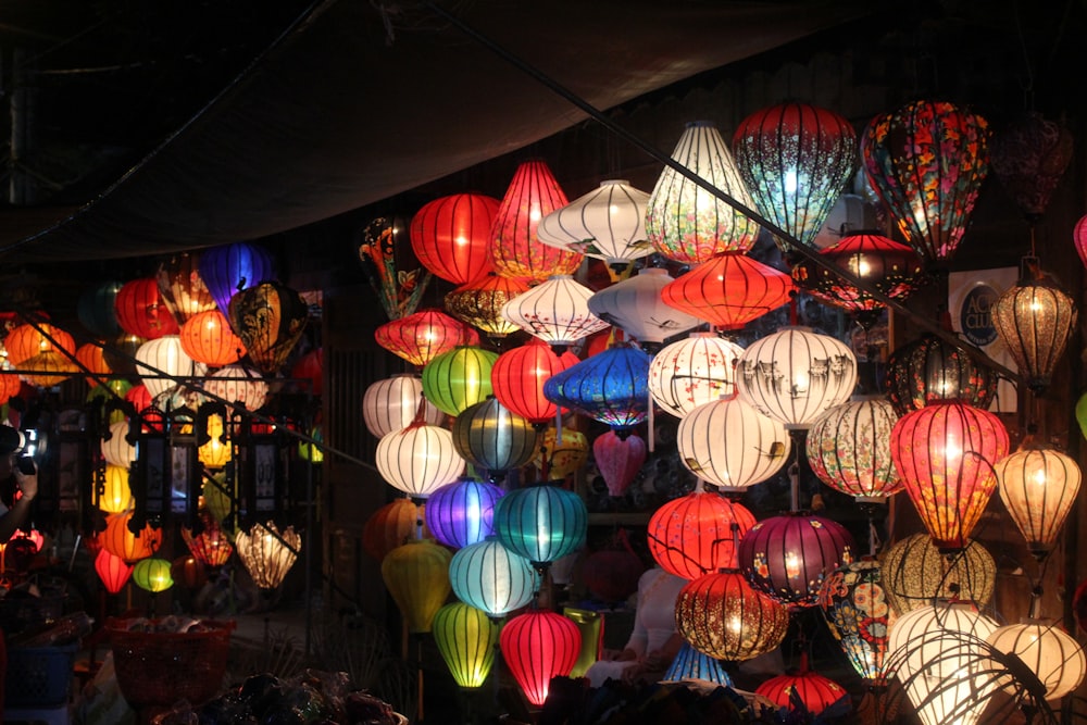a bunch of lanterns that are on a wall