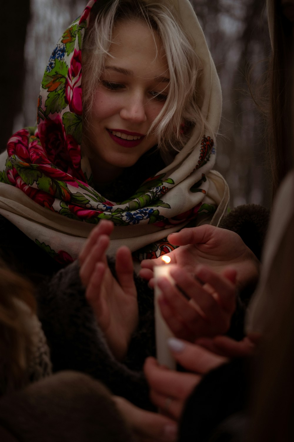 a woman holding a lit candle in her hands