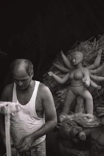 Artistic custom sculptures in various stages of completion on a studio workbench.