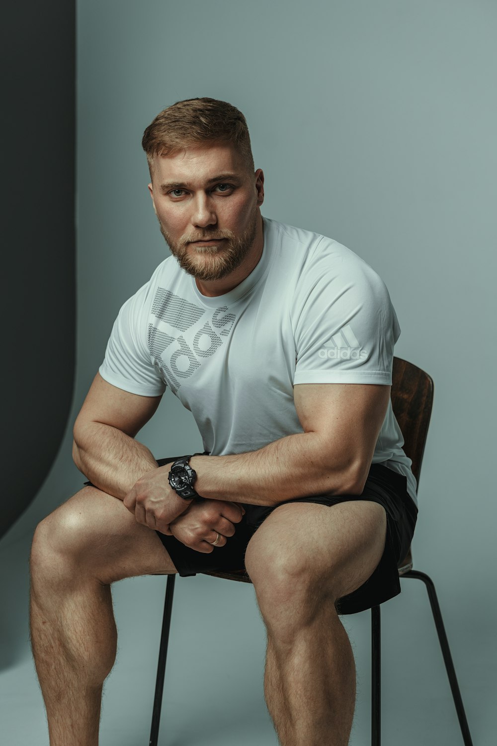 a man sitting on a chair with his legs crossed