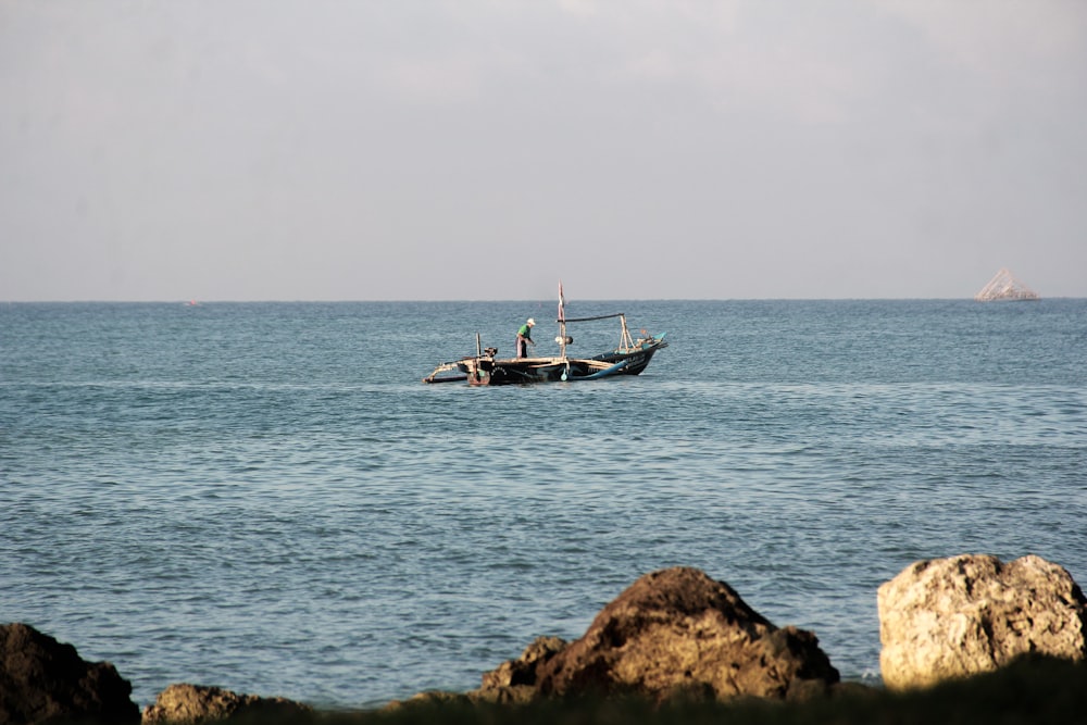 a couple of boats floating on top of a large body of water