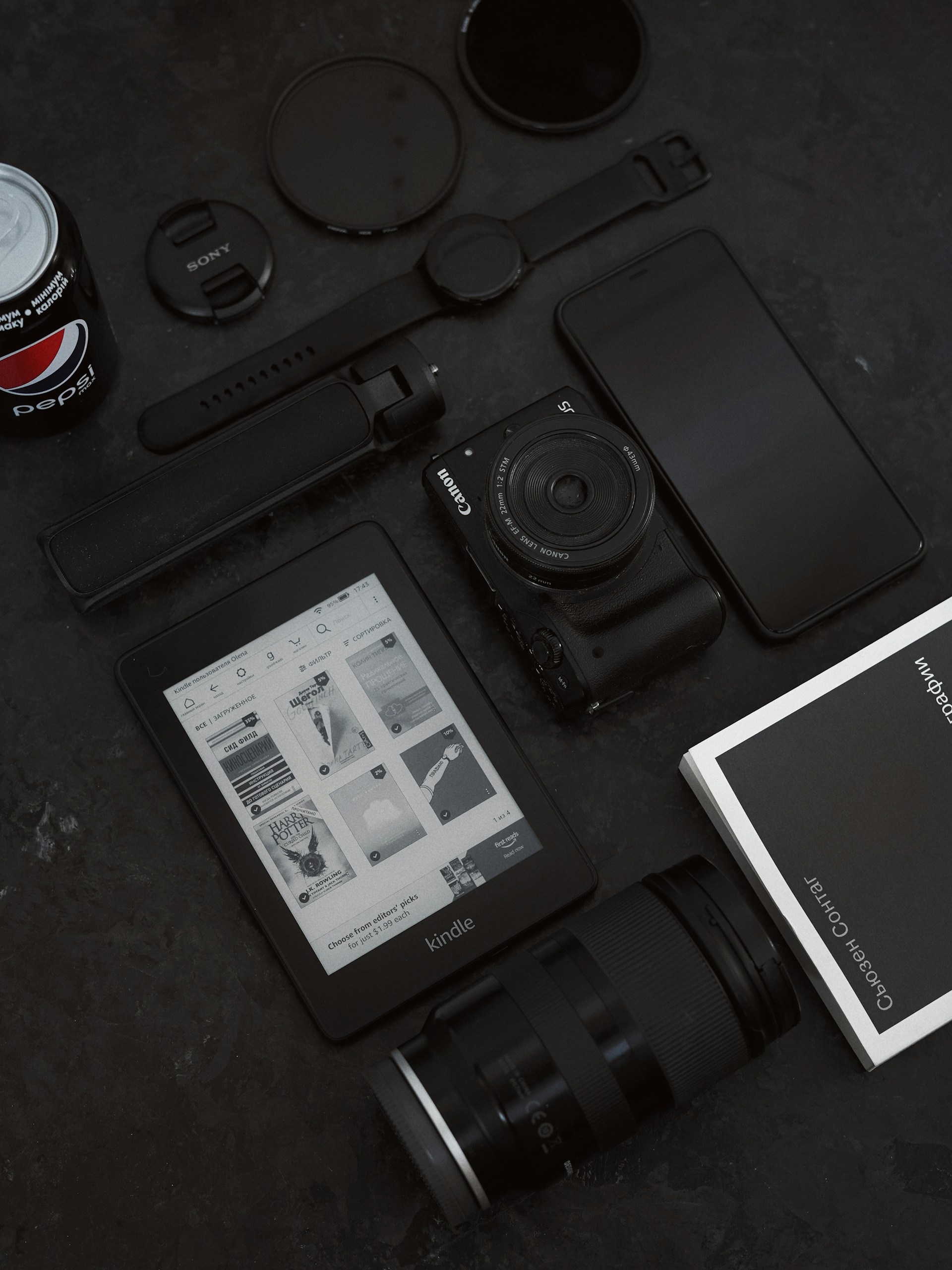 a camera, a tablet, and other items on a table