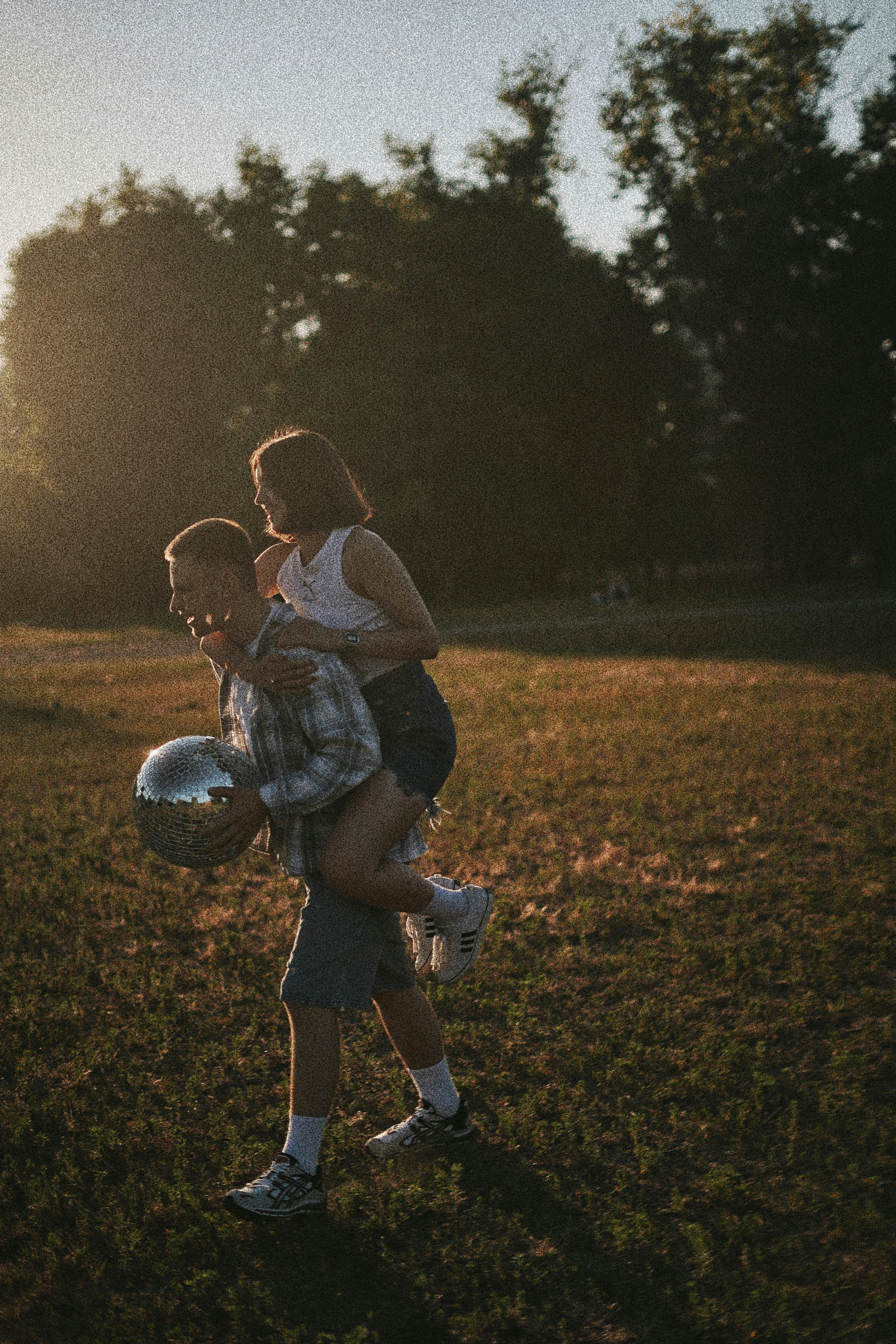 a couple of people that are standing in the grass