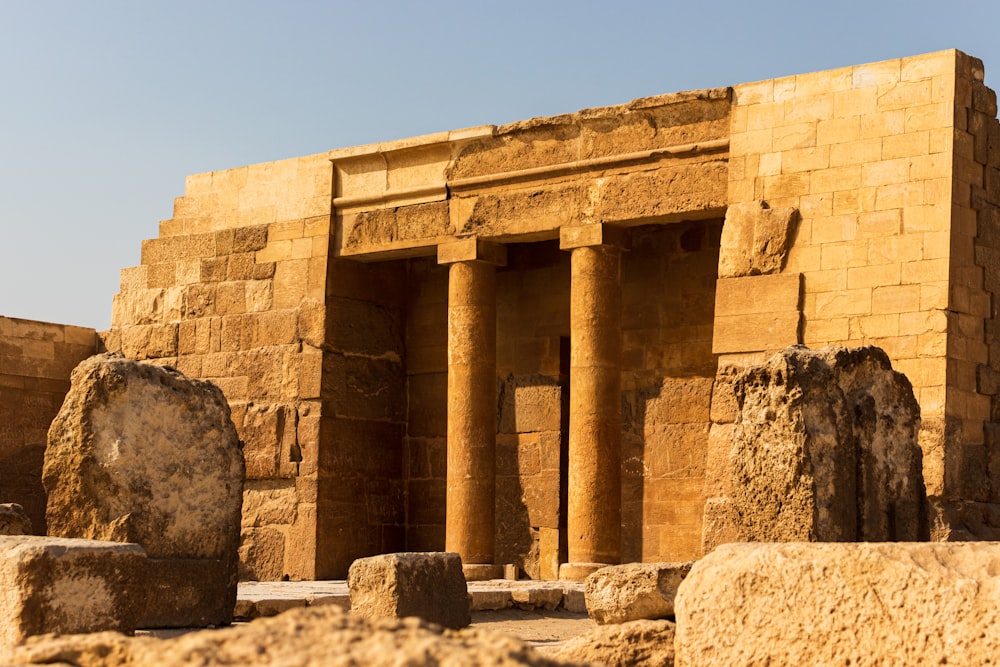 a stone structure with two large rocks in front of it