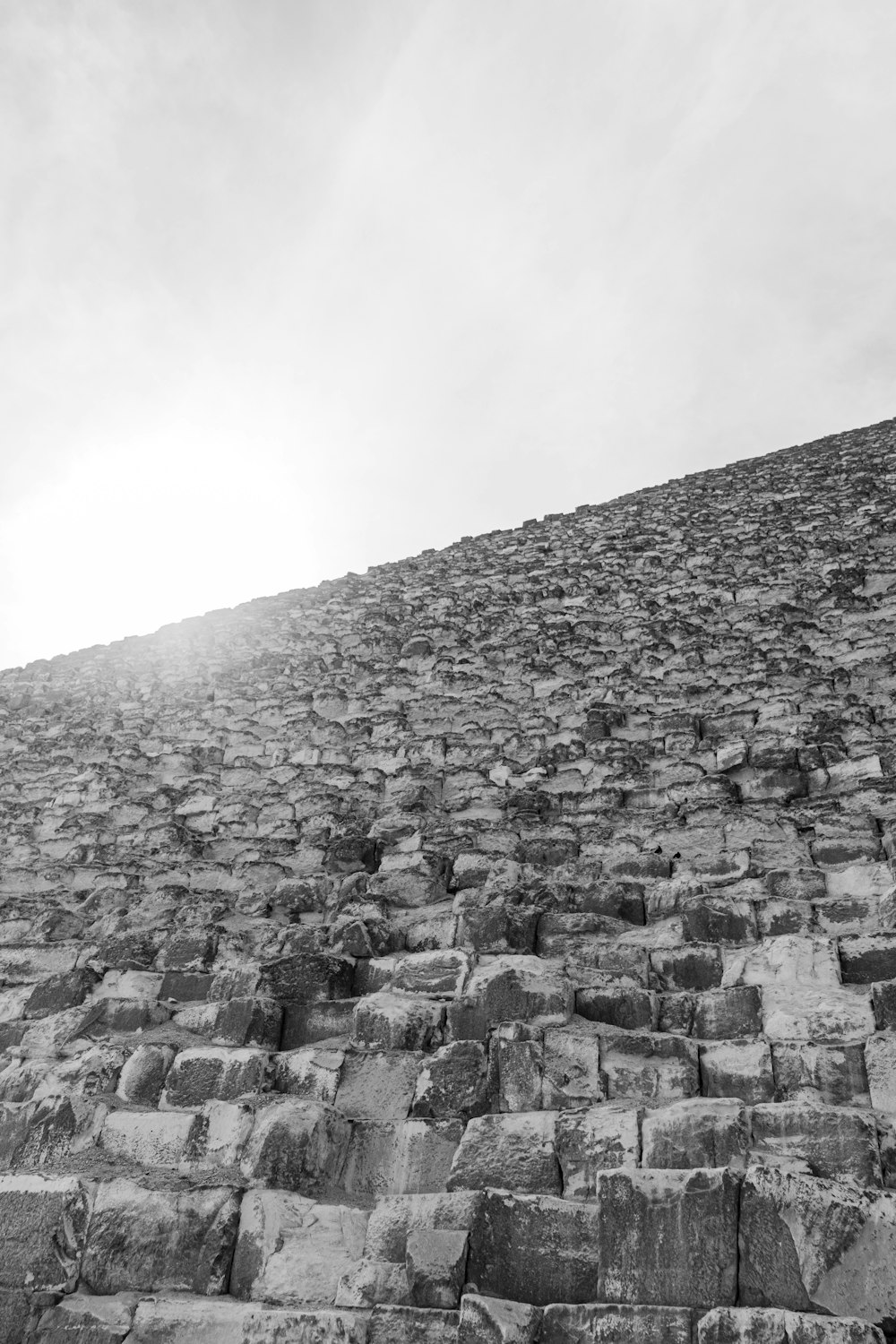 a black and white photo of a stone wall