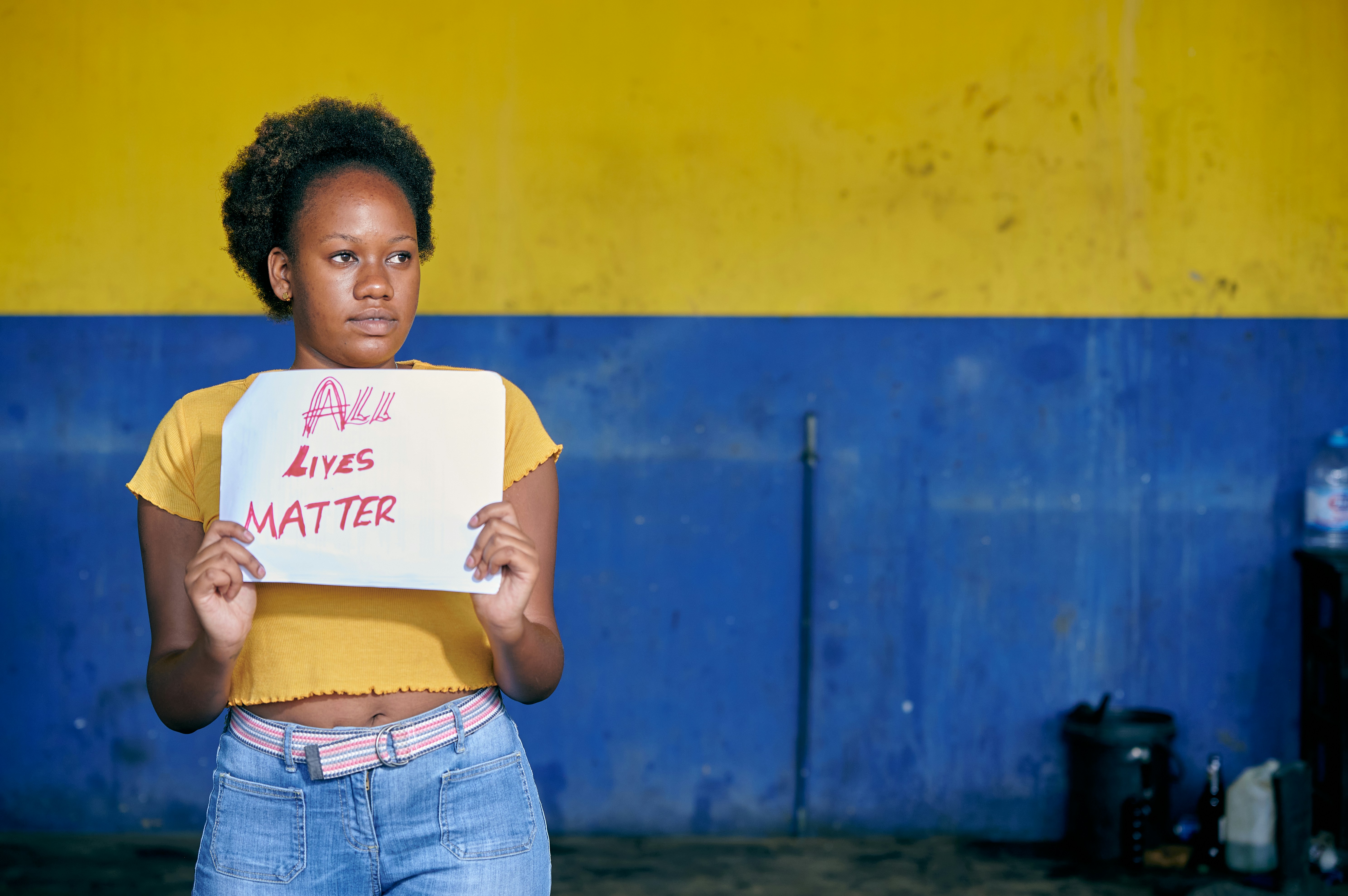 a young boy holding a sign